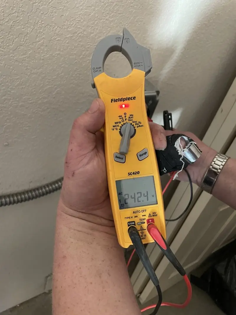 Voltage testing with clamp meter during Electrical Installation Services in Ephraim